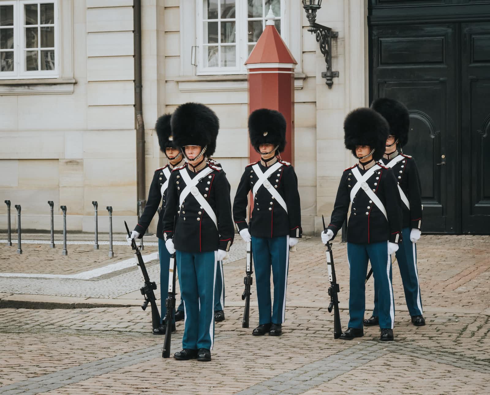 A group of Scots guards wear bearskin caps standing guard