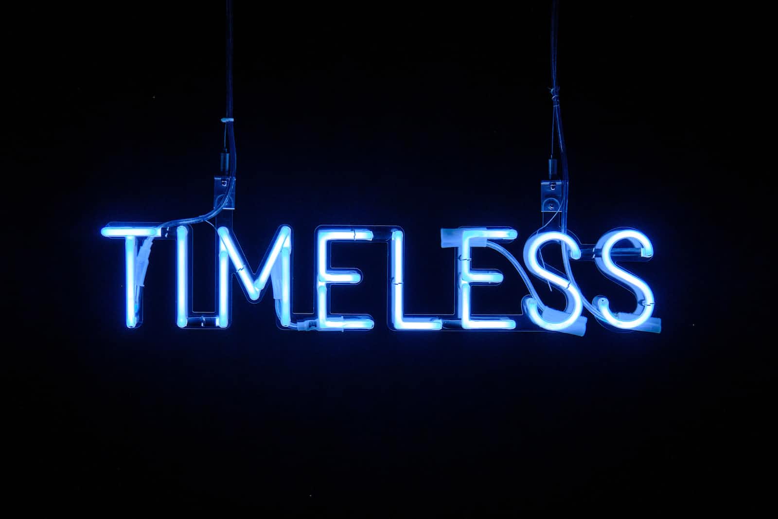 The word timeless in blue neon lights