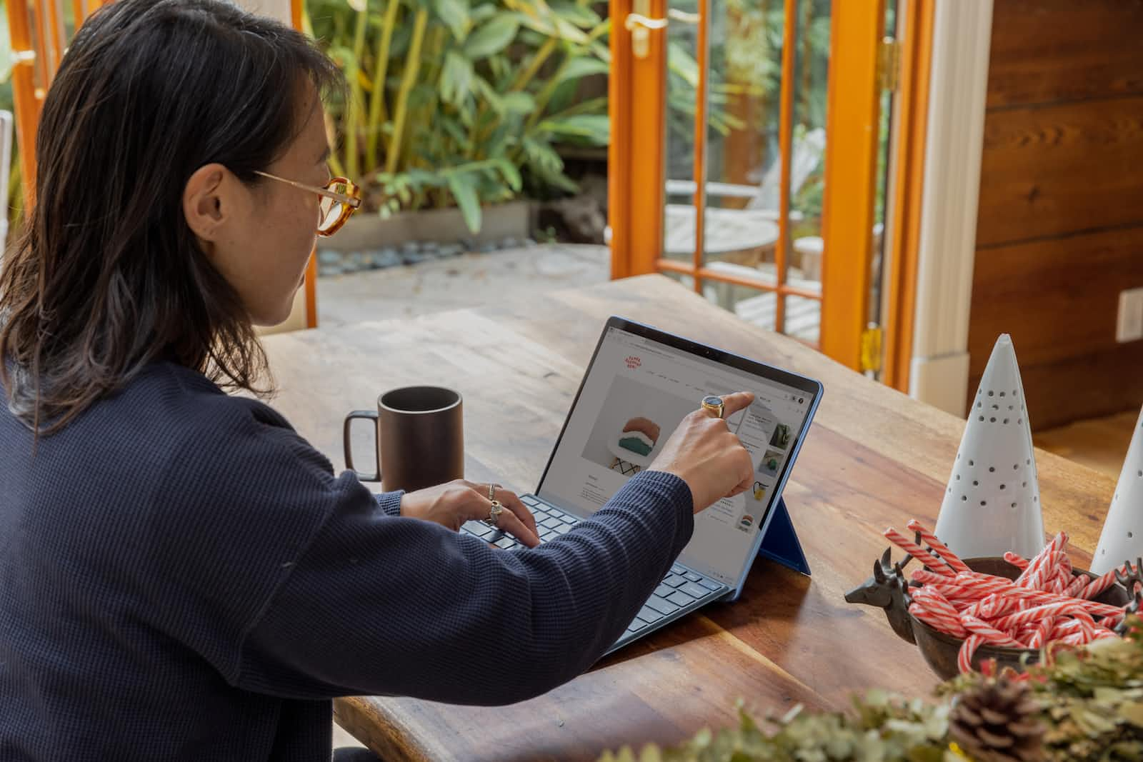 Woman using laptop computer to register a trademark for her business name