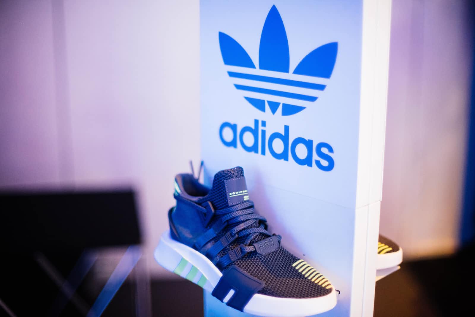 Adidas logo above an Adidas basketball shoe