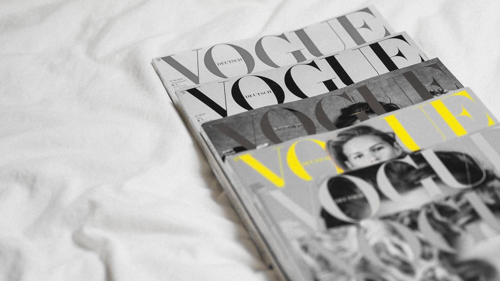 Four issues of Vogue magazines staggered on top of each other