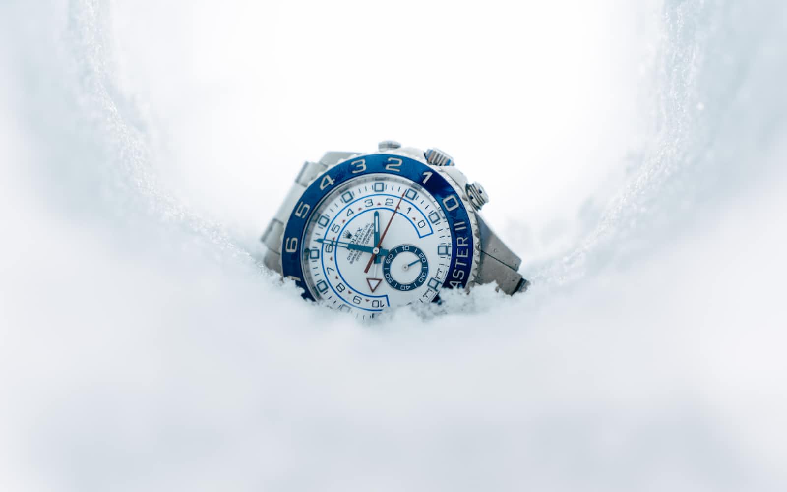 A Rolex watch sitting on snow