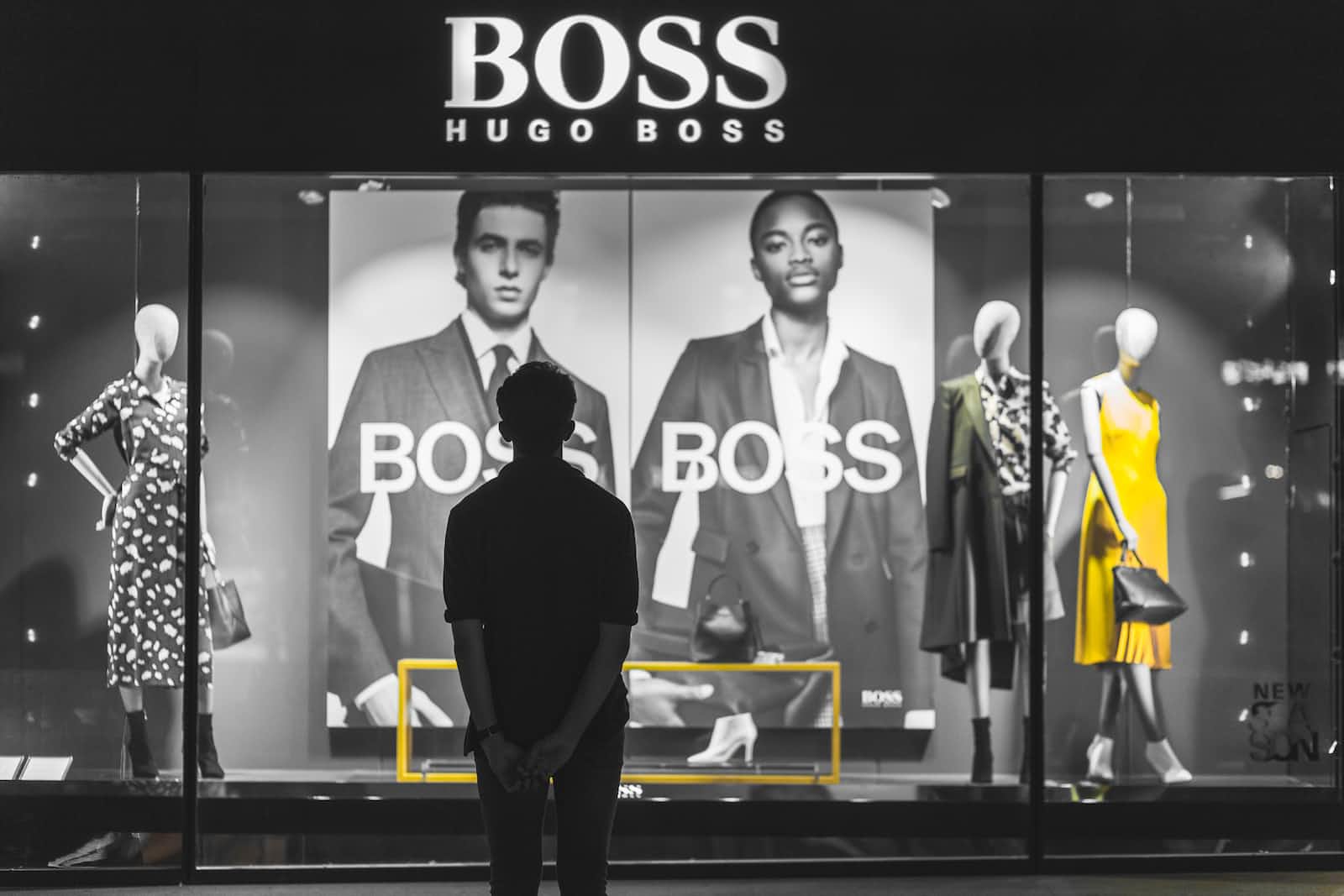 Man looking at Hugo Boss store