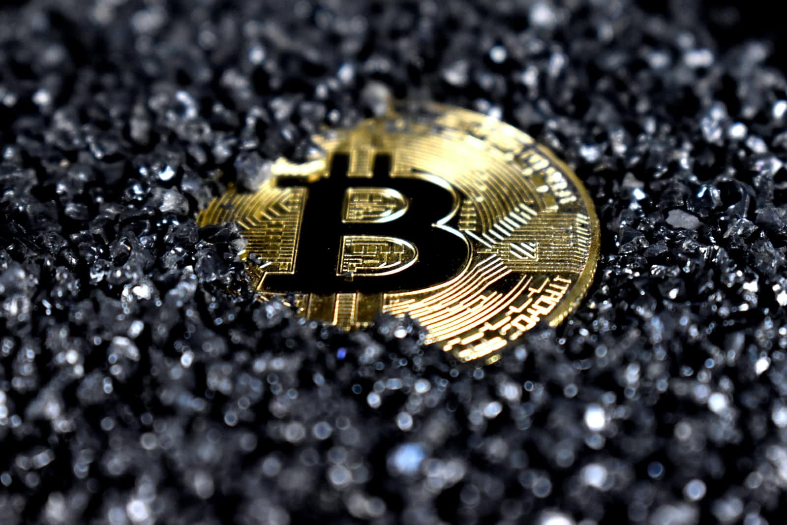 Bitcoin coin on black crystals