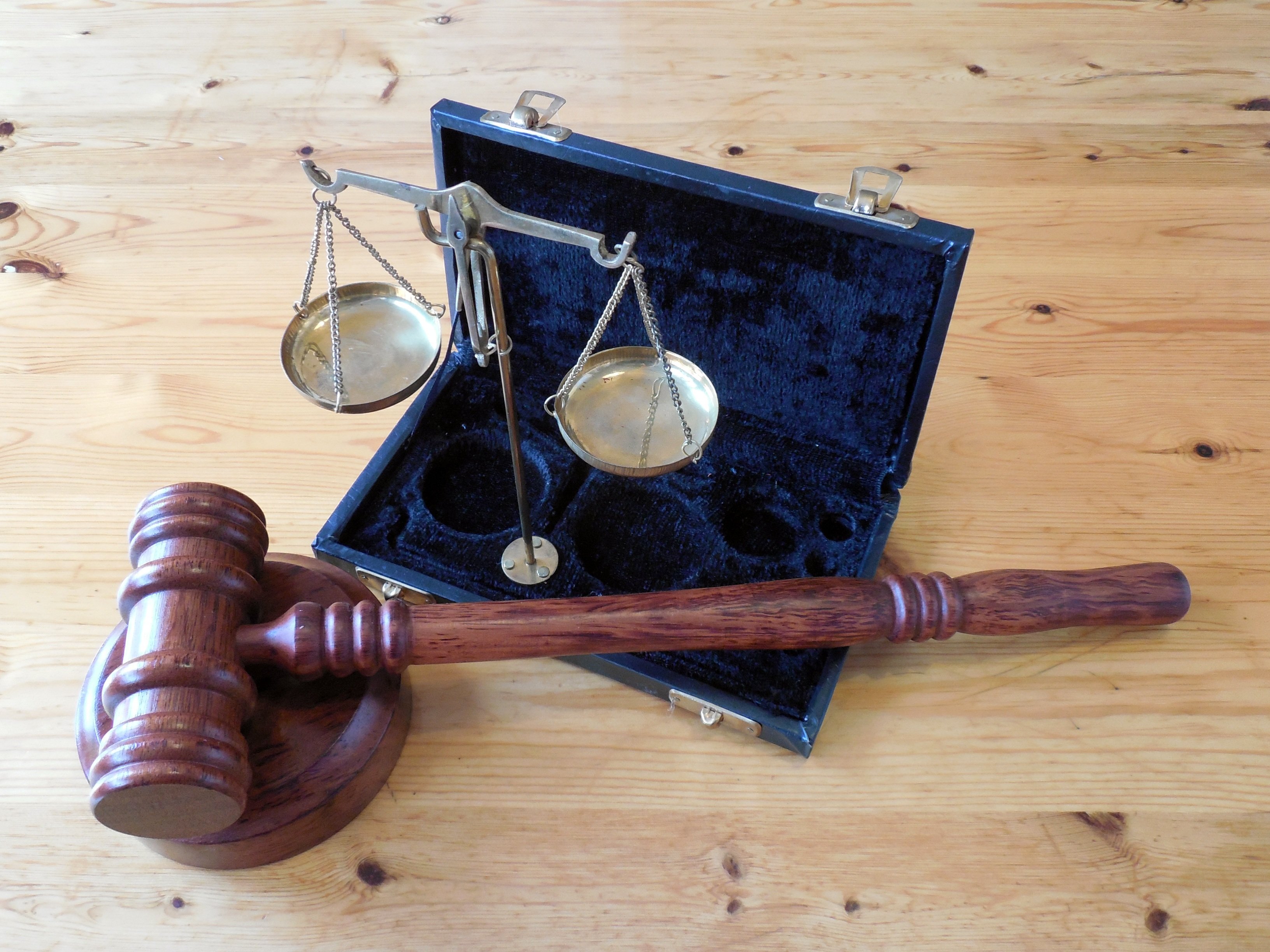 Scales of justice and a gavel on a desk